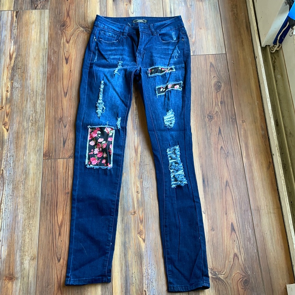 Jeans with floral backed holes